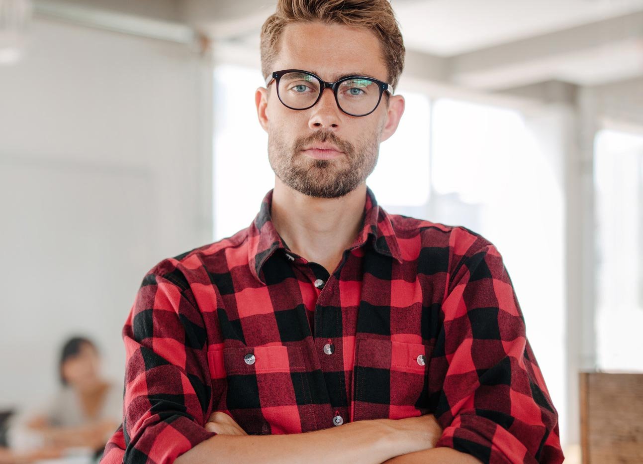 confident-young-entrepreneur-standing-in-office.jpg