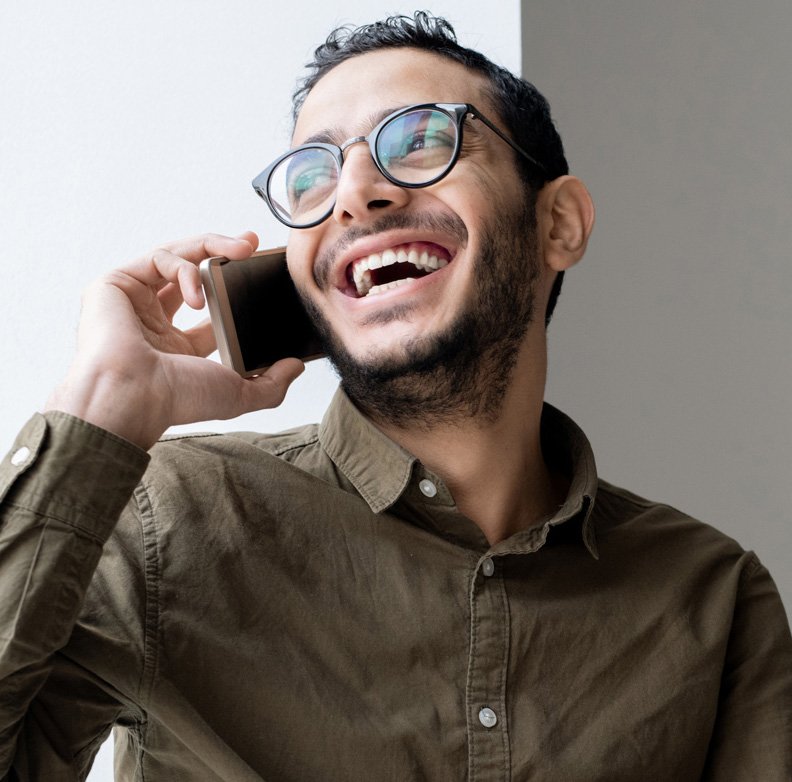 happy-young-casual-businessman-talking-on-mobile.jpg